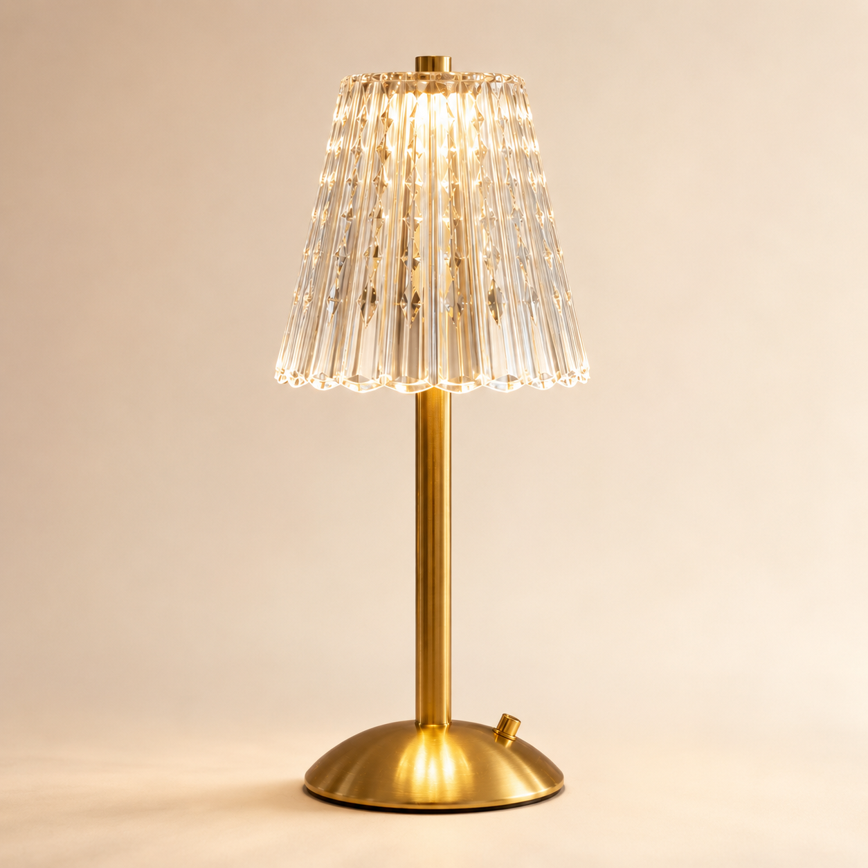 Elara gold crystal table lamp on a covered outdoor dining table at sunset