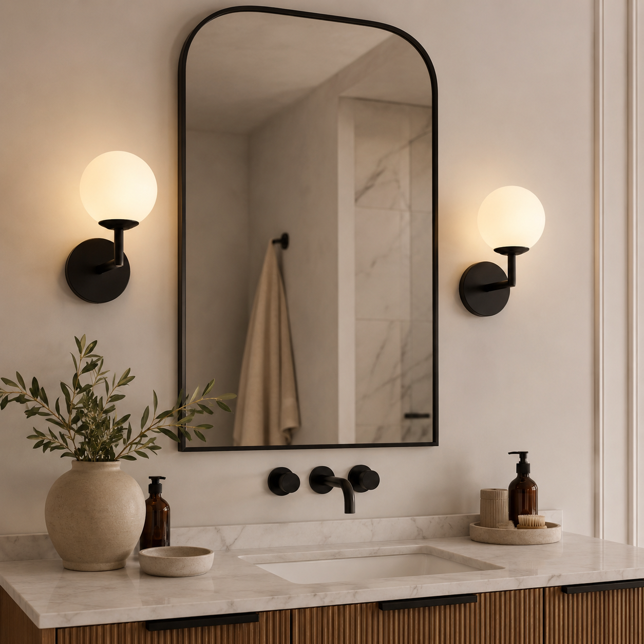 Modern black globe wall light illuminating an indoor stairway