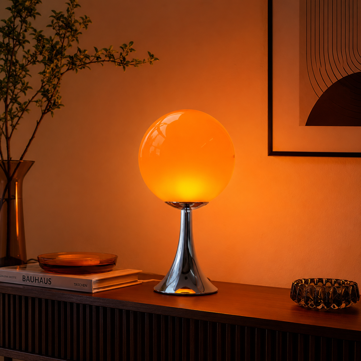 Orlena orange glass balloon table lamp styled on a dark wood console table