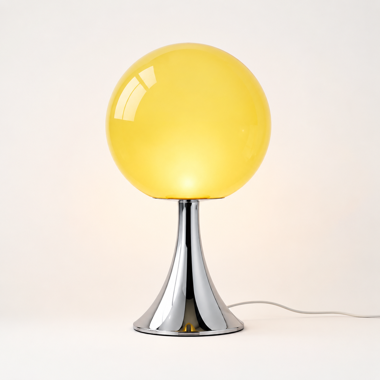 Orlena yellow glass balloon table lamp with chrome pedestal base