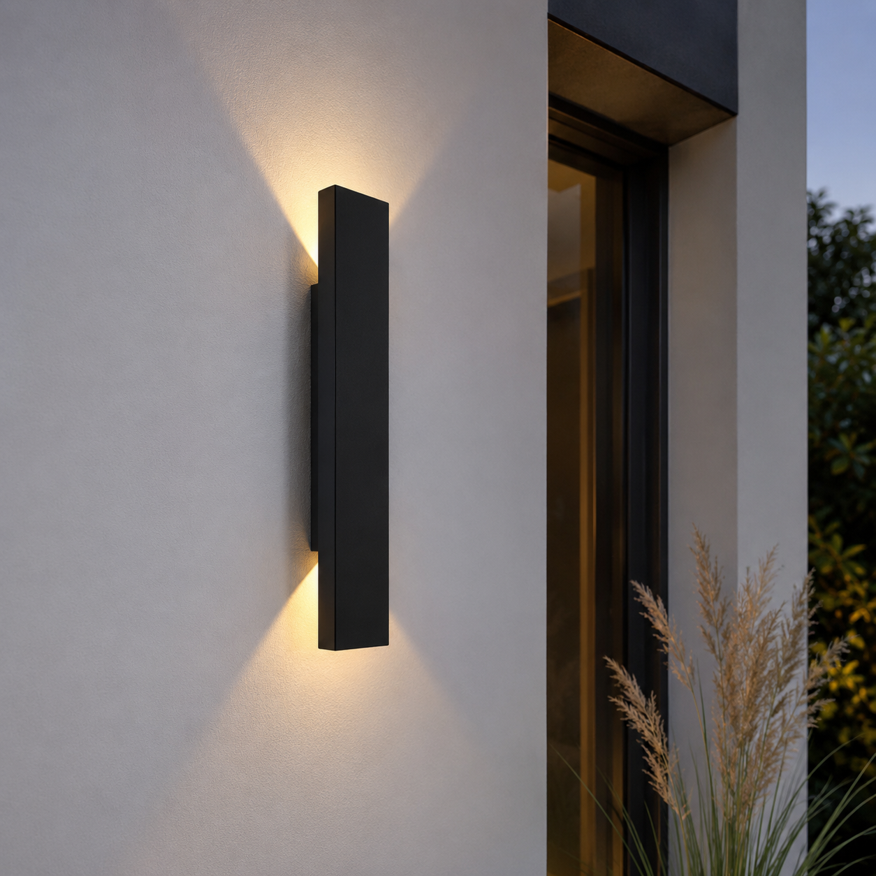 RainGlow black vertical outdoor wall lights illuminating a modern garden pathway