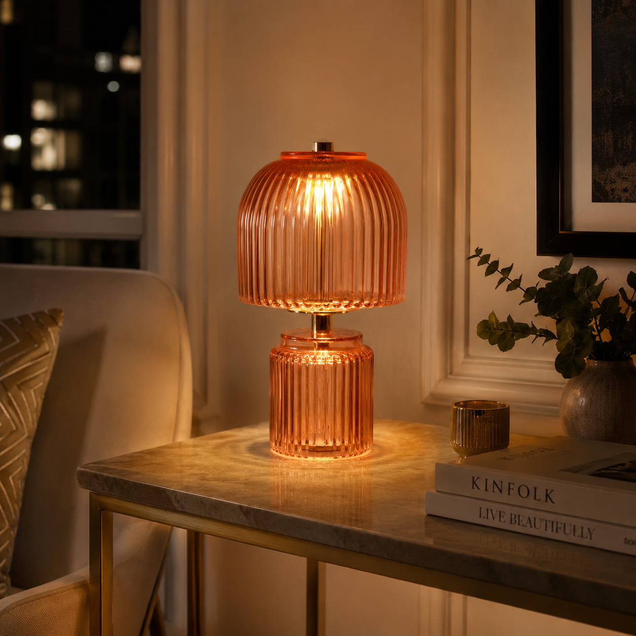 Ribbed stained glass table lamp with a warm illuminated shade and decorative glass body.
